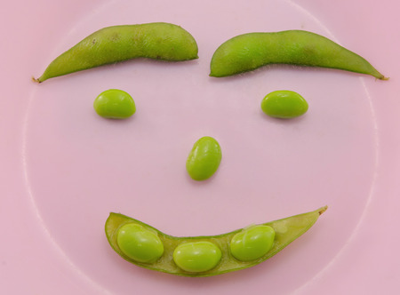 Green soybeans in pink dish.の写真素材