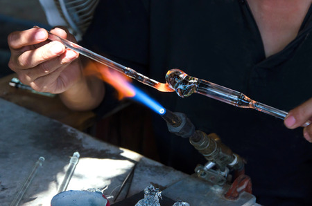 Closeup of art handmade a flame and melting glass piece.の写真素材