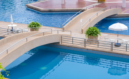 stone bridge crossing on swimming pool.の写真素材