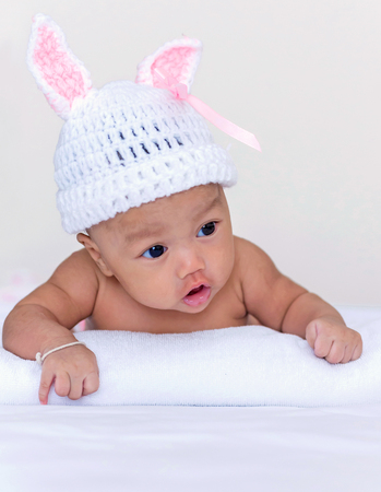 Portrait of cute newborn baby girl on the bed.の写真素材
