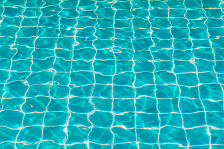 blue swimming pool with sunny reflections.