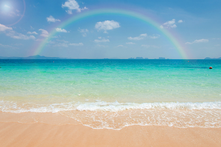 Colorful rainbow over a tropical beach of Andaman Sea, Thailand.の写真素材