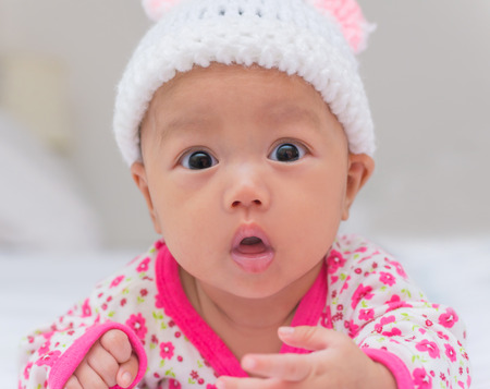Portrait of cute newborn baby girl on the bed.の写真素材