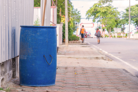 trash cans in the park beside the walk way.の写真素材