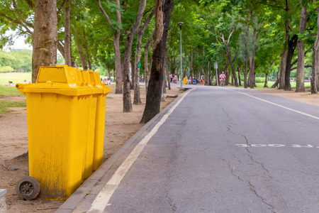 trash cans in the park beside the walk way.の写真素材