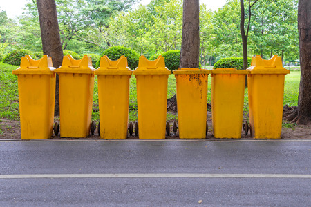trash cans in the park beside the walk way.の写真素材