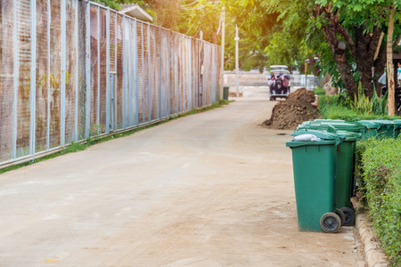 trash cans in the park beside the walk way.の写真素材