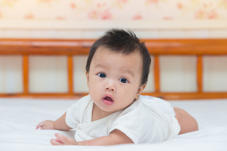 Portrait of cute baby girl on the bed.の写真素材