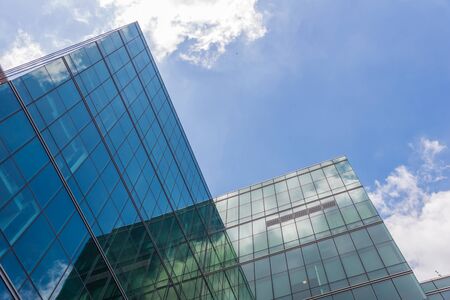 skyscraper against sky and building in city.の写真素材