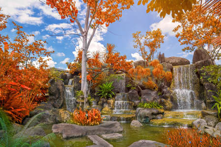 Waterfall in garden at public park with blue sky.の写真素材