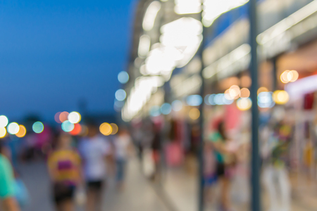 Abstract of blurred people walking in shopping centre at twilight night.の写真素材