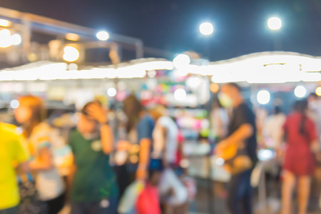 Abstract of blurred people walking in shopping centre at twilight nightの写真素材