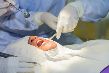The doctor cleaning the teeth patient with ultrasonic tool.の写真素材
