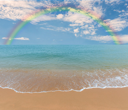 Colorful rainbow over a Tropical beach of Andaman Sea, Thailand.の写真素材