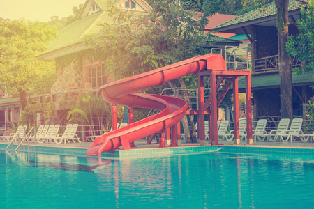 blue swimming pool with water slide at hotel.のeditorial素材