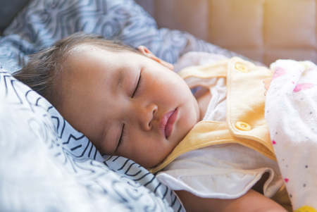 portrait of sleeping baby, childhood and people concept.の写真素材