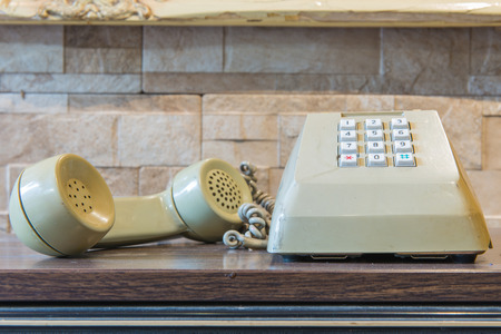 retro telephone on wooden table, vintage style.