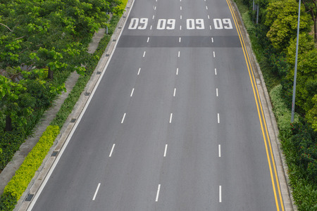 top view of curving road with trees in a public park.の写真素材