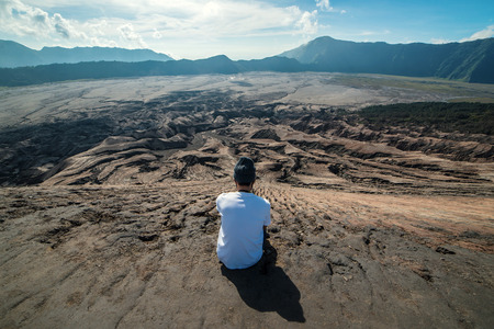 Man on top of Layer Volcanic ash as sand ground of Mount Bromo volcano (Gunung Bromo) at Bromo Tengger Semeru National Park, East Java, Indonesia.の写真素材