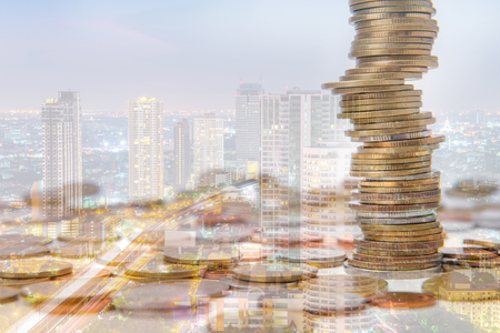 Double exposure of city and coins for finance and business concept.の写真素材