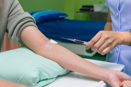 Nurse collecting a blood from patient in hospital.の写真素材