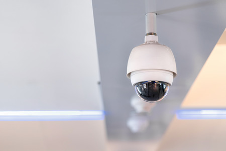 CCTV security camera on ceiling operating inside the building for crime protect.の写真素材