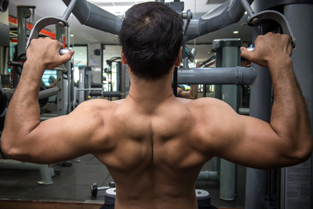personal fitness trainer show his muscles or Strong bald bodybuilder with six pack.