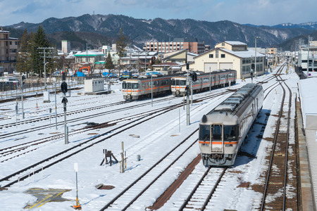 Train on the railway in snow day at Takayama Station,Japan.のeditorial素材