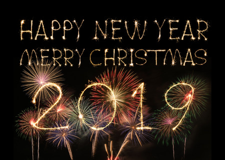Happy New Year 2019 text hand written sparkles fireworks with Colorful fireworks of various colors at night.の写真素材