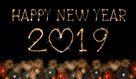 Happy New Year 2019 text handmade written sparkles fireworks with Colorful fireworks of various colors at night.の写真素材