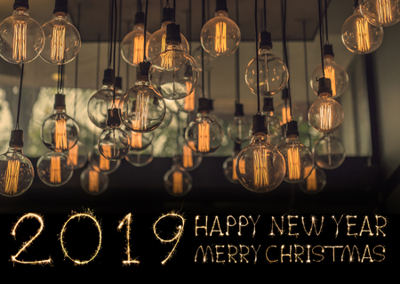Happy New Year 2019 text hand written sparkles fireworks with Vintage Lighting decor for building interiors.の写真素材