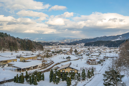 landscape of house and trees in snow with wintry frosty day.の写真素材