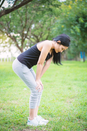 Young female warm up before exercise at the park.