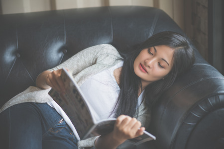 Portrait of woman reading a book at coffee cafe.