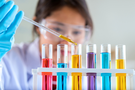 scientist with equipment and science experiments, laboratory glassware containing chemical liquid for research or analyzing a sample into test tube in laboratory.の写真素材