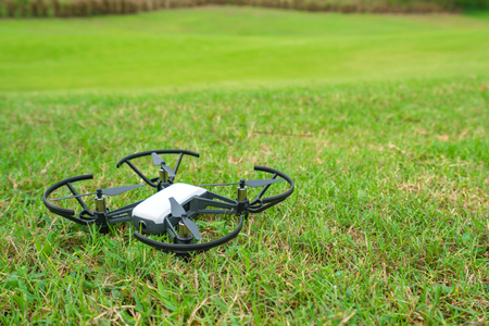 Flying drone above the green grass golf court.