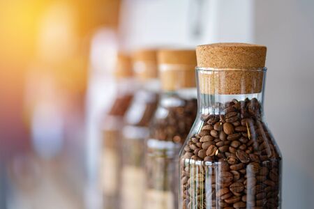 coffee beans in the glass bottle at cafe.の写真素材