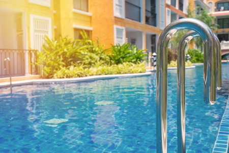 blue swimming pool at hotel with stairのeditorial素材
