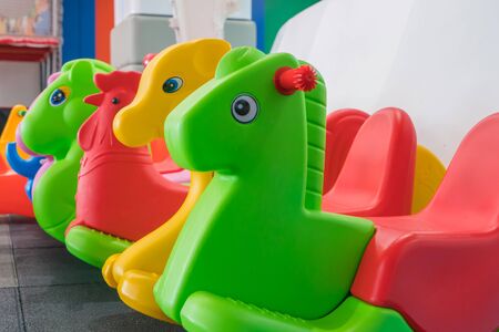 Kids colorful horse rocking chair on indoor playground for the kid's zone.の写真素材