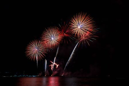 Colorful fireworks of various colors at night with celebration and anniversary conceptの写真素材