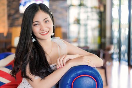 Portrait of beautiful young woman smiling at vintage restaurant cafe.の写真素材
