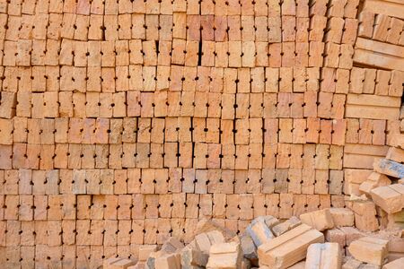 brick block in residential building construction or Stack of red bricks for background.