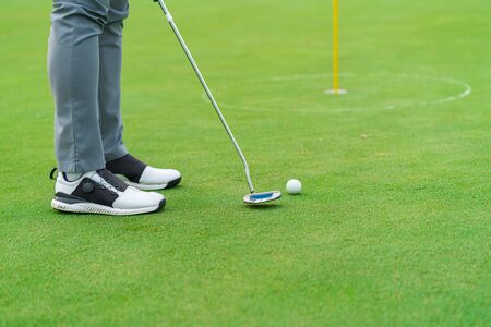 Golfer preparing for a putt Golf ball on the green during golfcourse.の写真素材