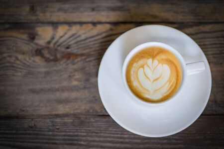 latte art coffee or cappuccino on wooden table background.の写真素材