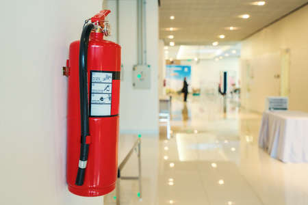 Fire extinguisher in front of room at apartment.の写真素材