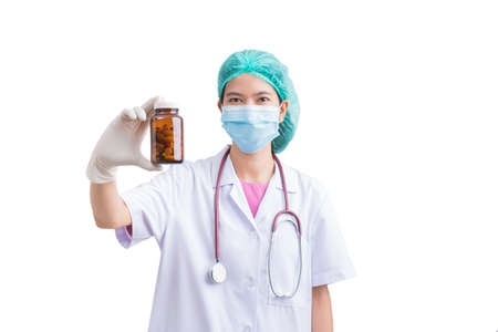 Doctor woman holding pill or medication in capsule. concept of pharmacist, drugs, diet pill, antibiotic or vitamin.の写真素材