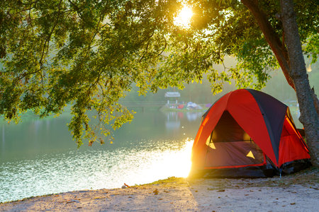Tourist tent in Camping among meadow in the mountain near lake at national park.の写真素材
