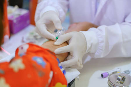 Nurse collecting a blood from patient in hospital.
