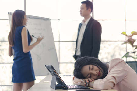 business woman work from home sleeping on the workplace and feel tired after working on tablet computer, Lifestyle woman relax after working at home concept. depressed businesswoman.の写真素材