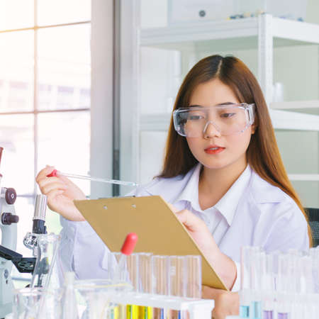 Doctor and microbiologist with vacuum tubes for samples with COVID 19 infection atypical pneumonia virus in laboratory.の写真素材